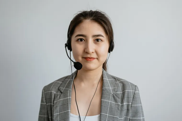 A customer-support agent wearing a headset at a workstation